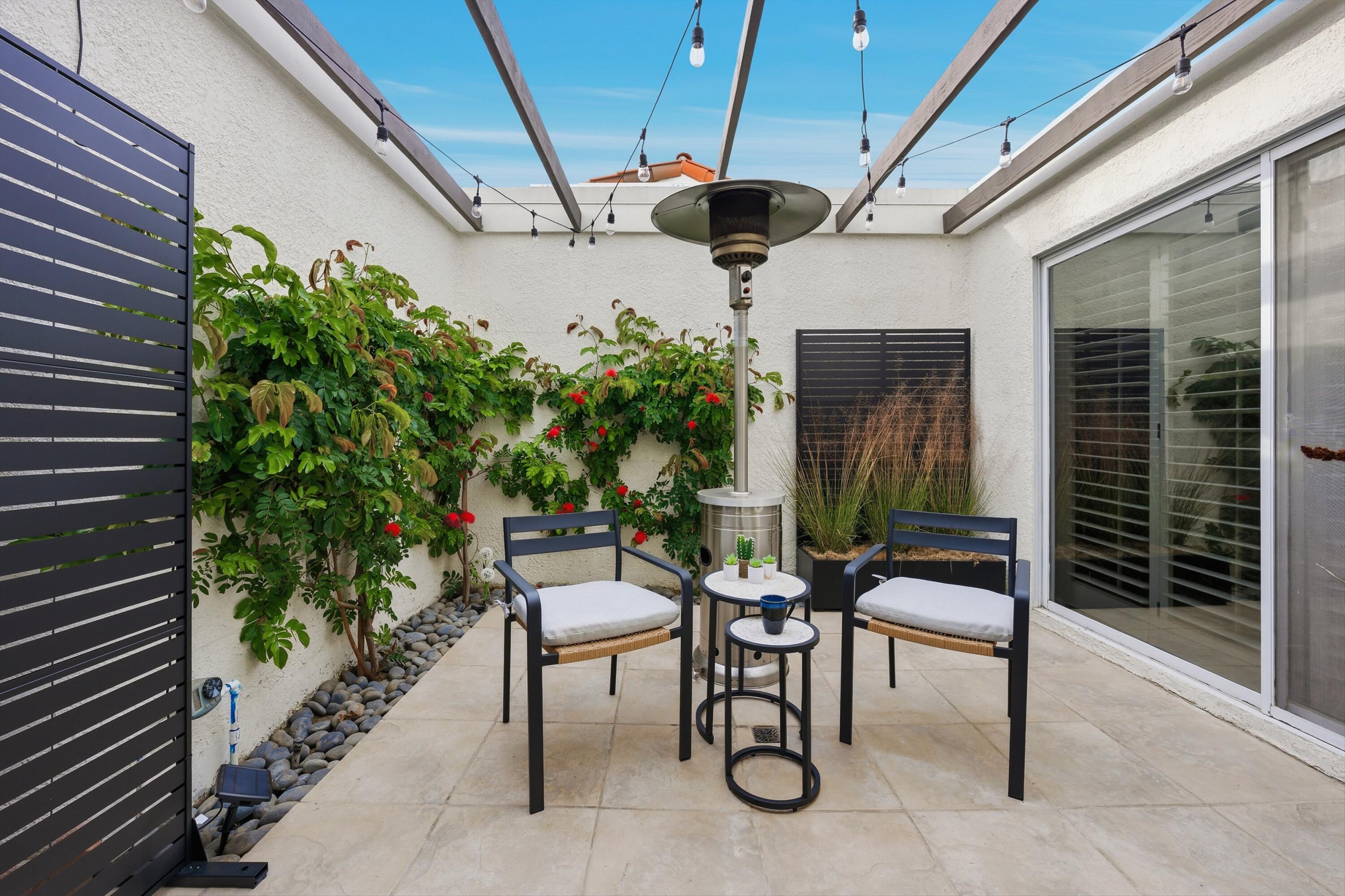 23 Leon Way Rancho Mirage, CA 92270 - Photo 26 of 32 a patio with table and chairs and potted plants