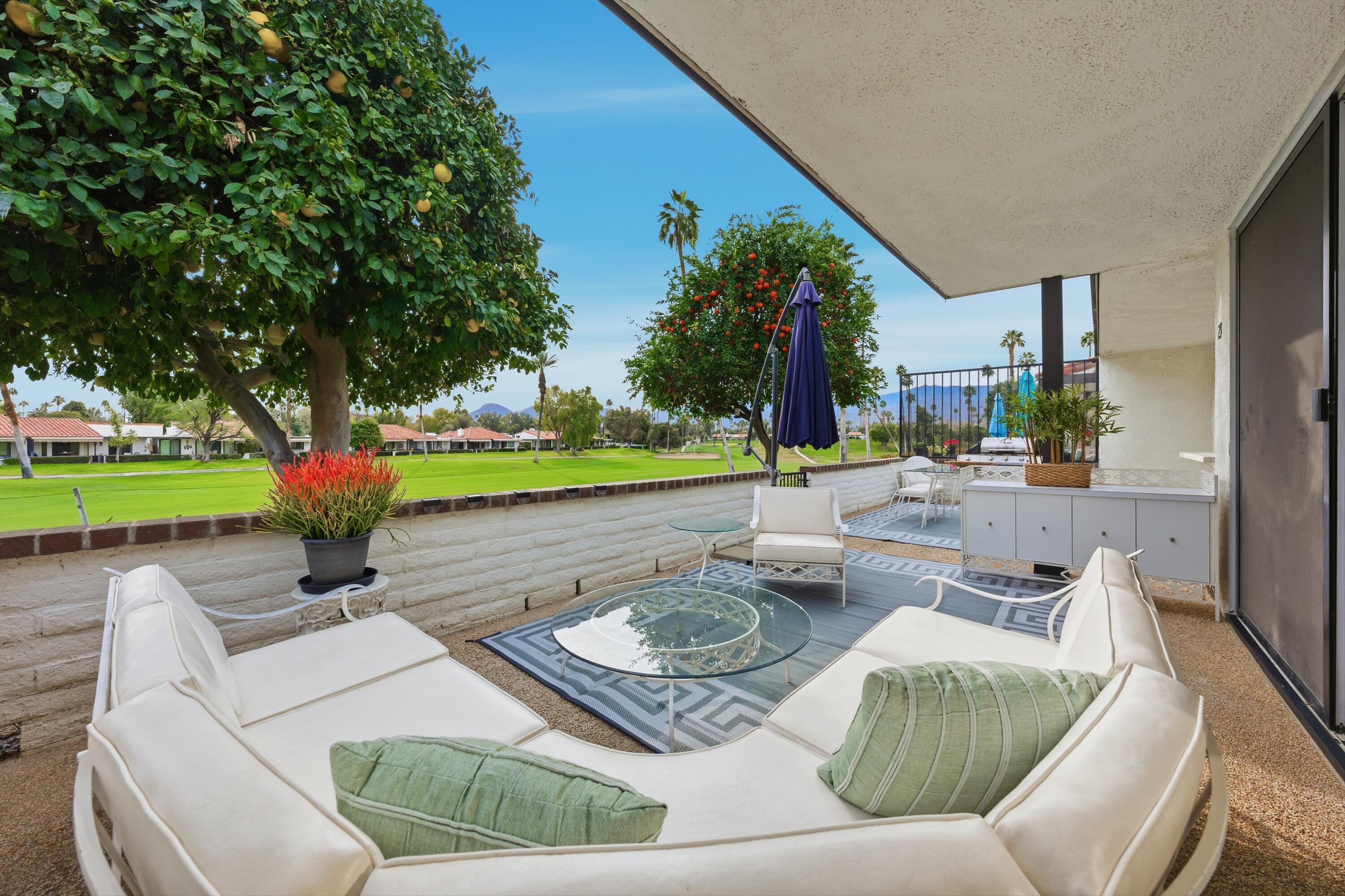 23 Leon Way Rancho Mirage, CA 92270 - Photo 30 of 32 a view of a patio with couches and a fire pit