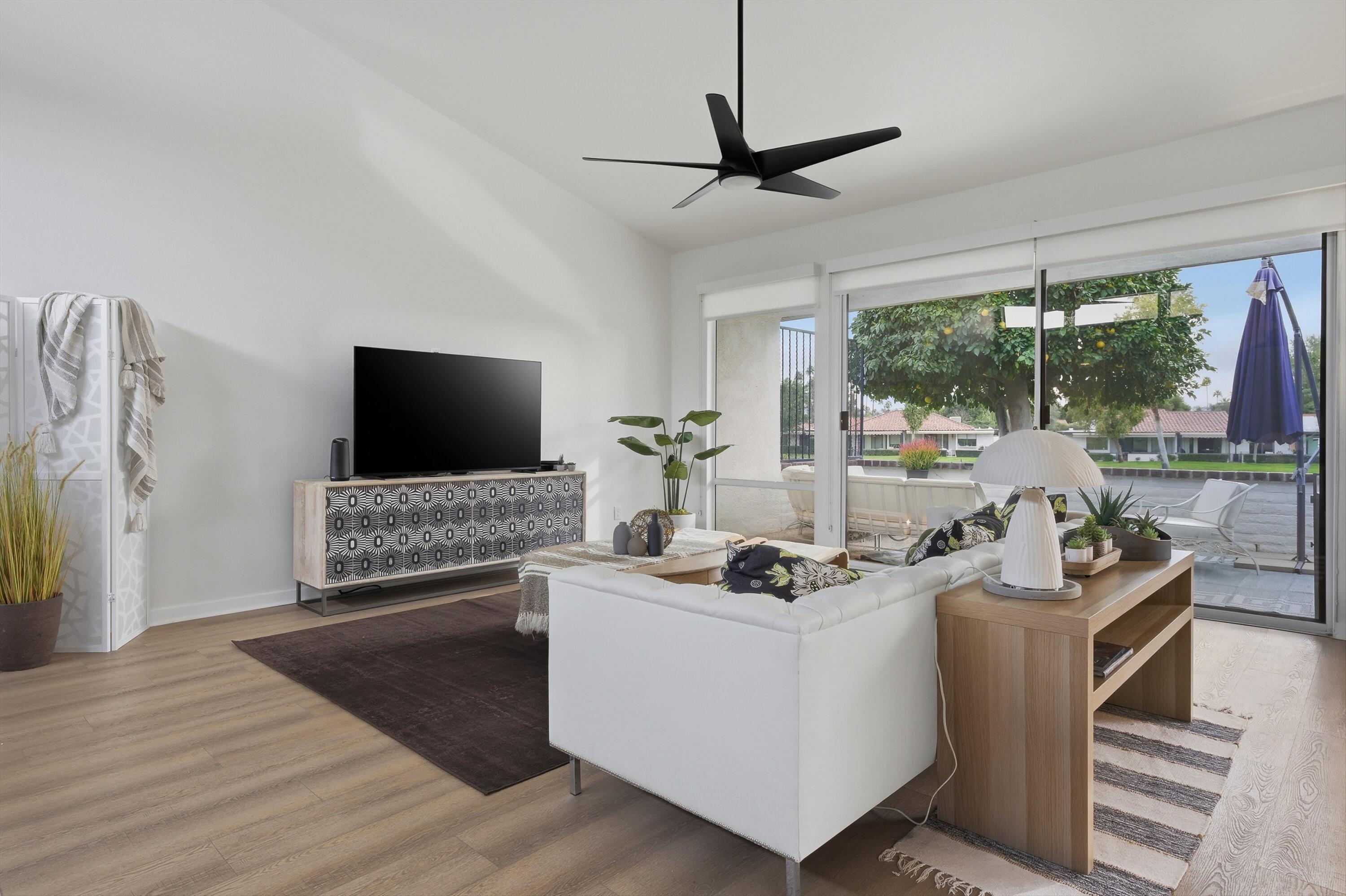 23 Leon Way Rancho Mirage, CA 92270 - Photo 4 of 32 a living room with furniture and a flat screen tv