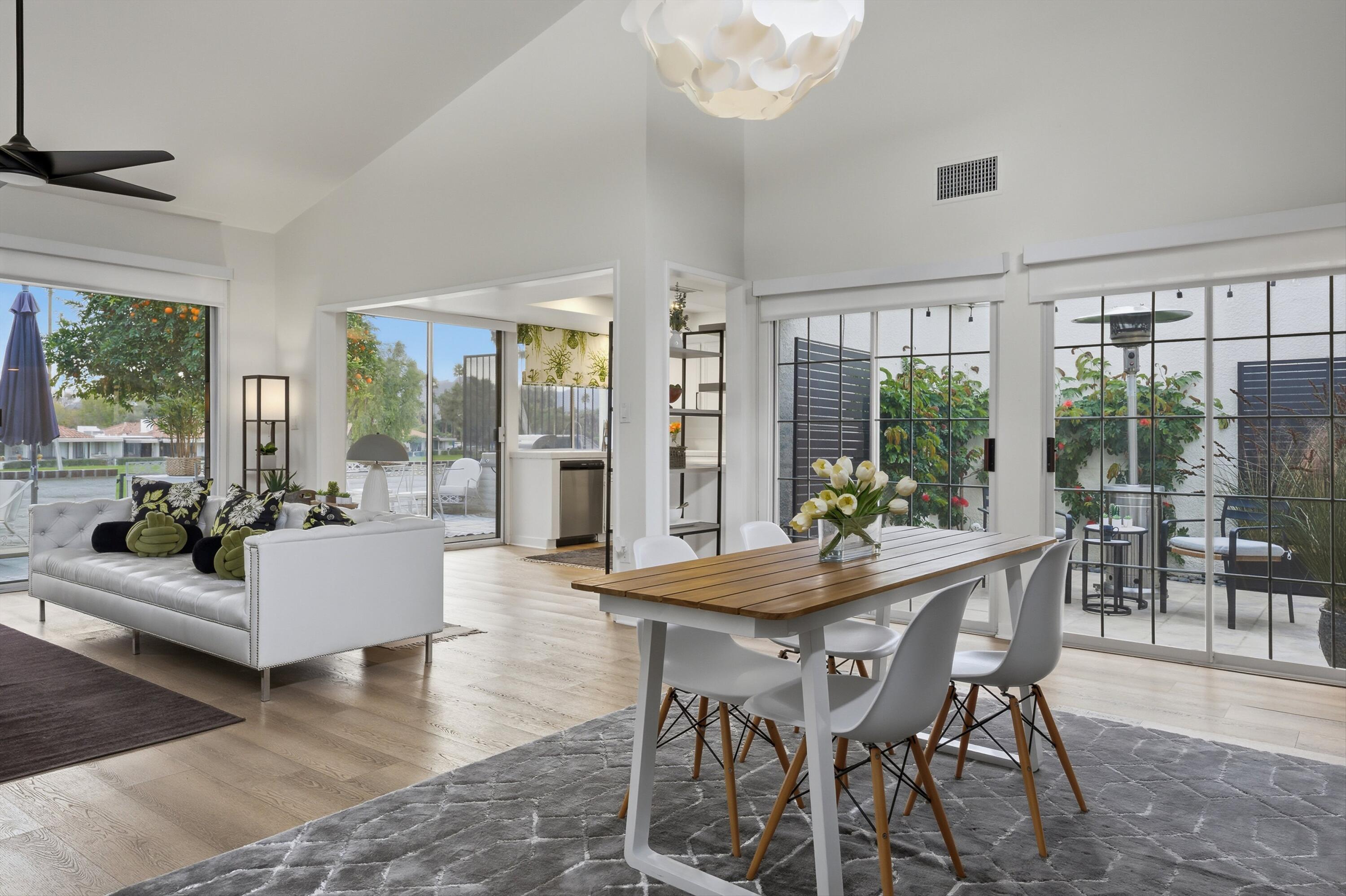 23 Leon Way Rancho Mirage, CA 92270 - Photo 9 of 32 a dining room with furniture a chandelier and wooden floor
