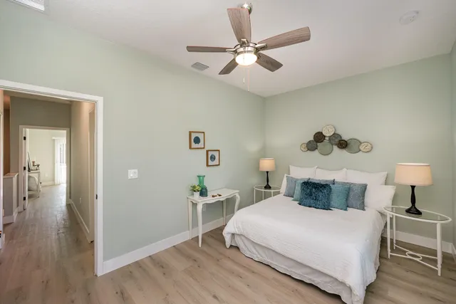 a bedroom with a bed and a chandelier