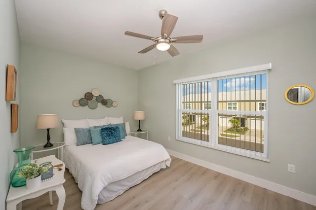 a bedroom with a large bed and a window