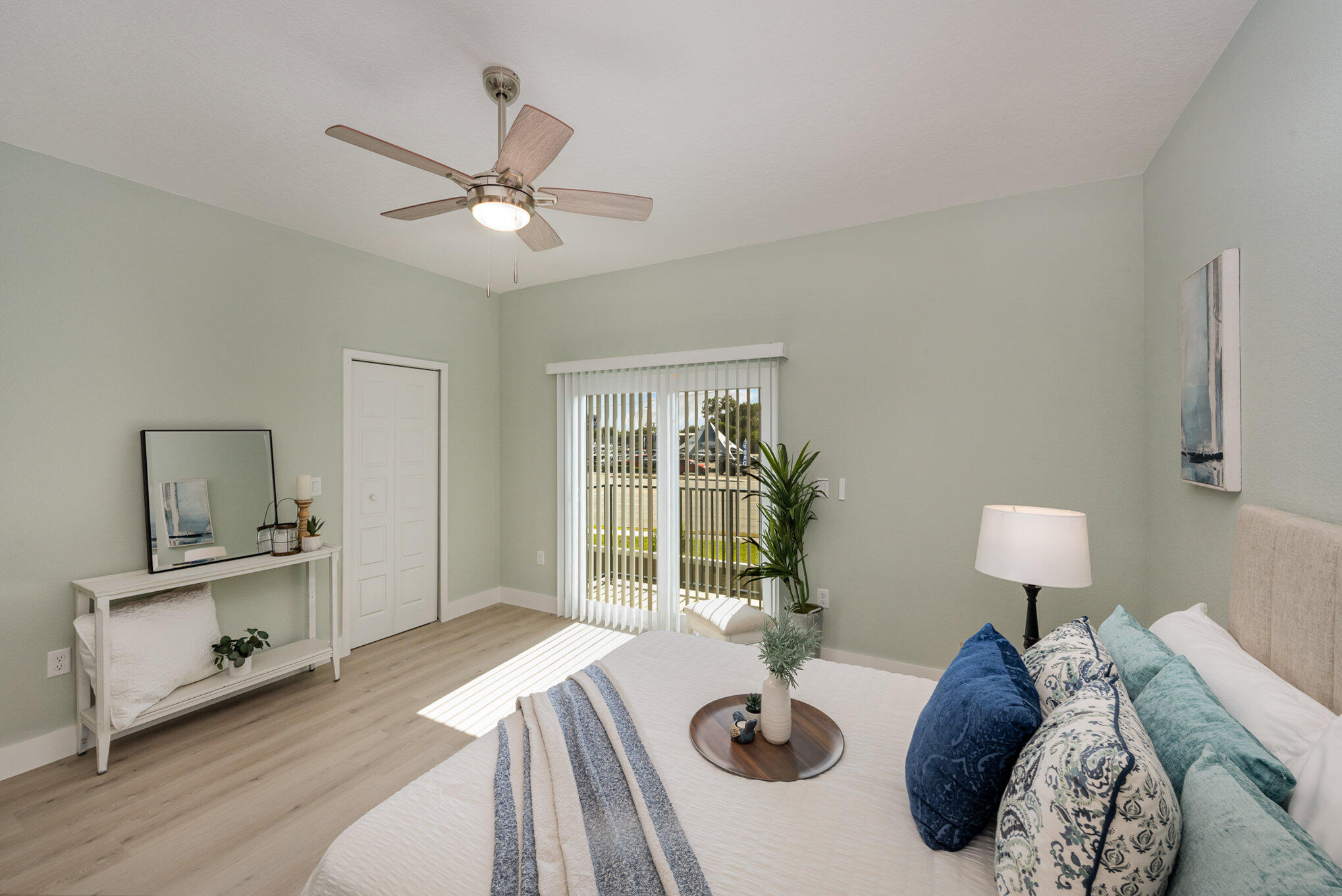 900 Paddleboard Court Melbourne, FL 32935 - Photo 16 of 32 a bedroom with a bed and a chandelier