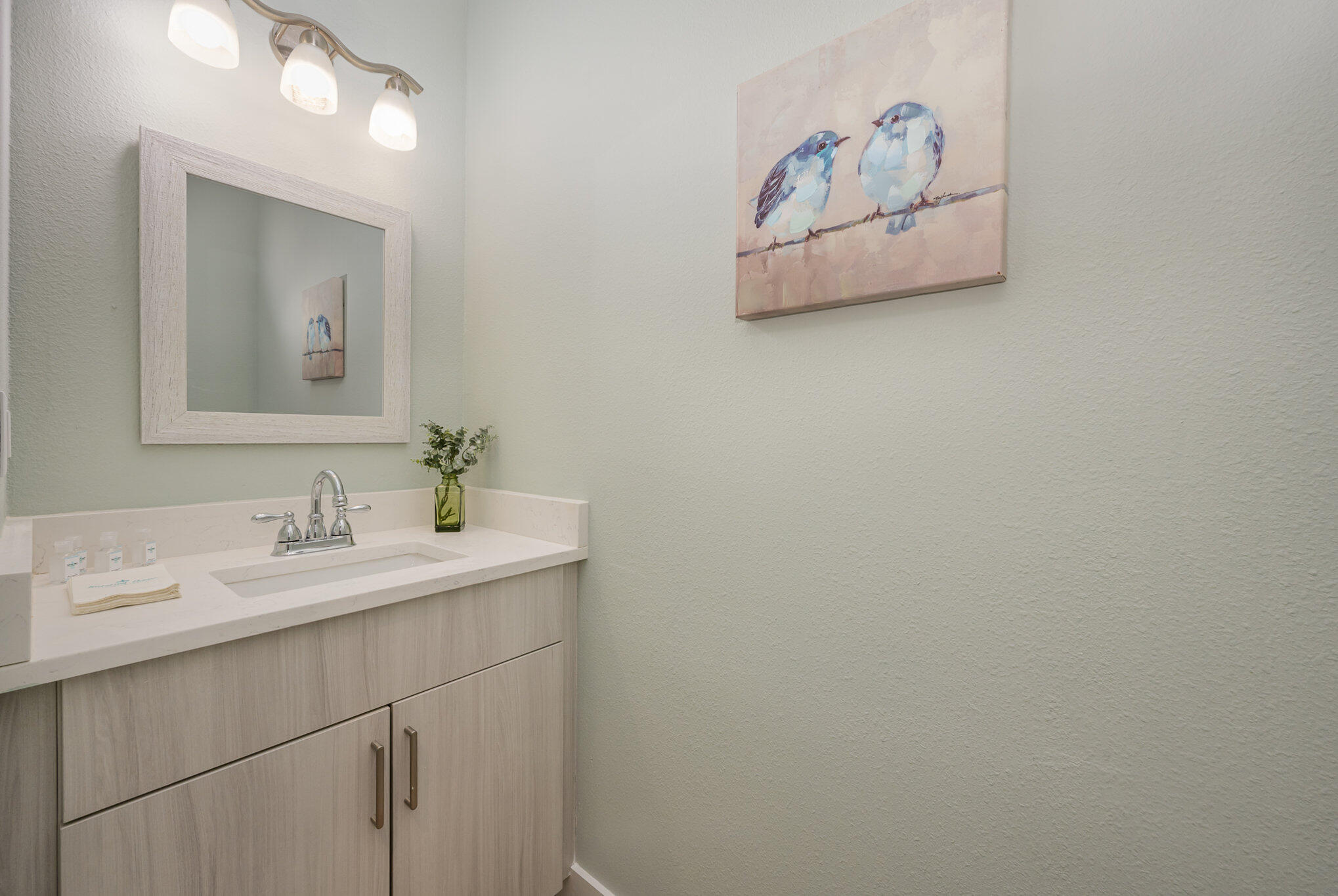 900 Paddleboard Court Melbourne, FL 32935 - Photo 17 of 32 a bathroom with a sink and a mirror