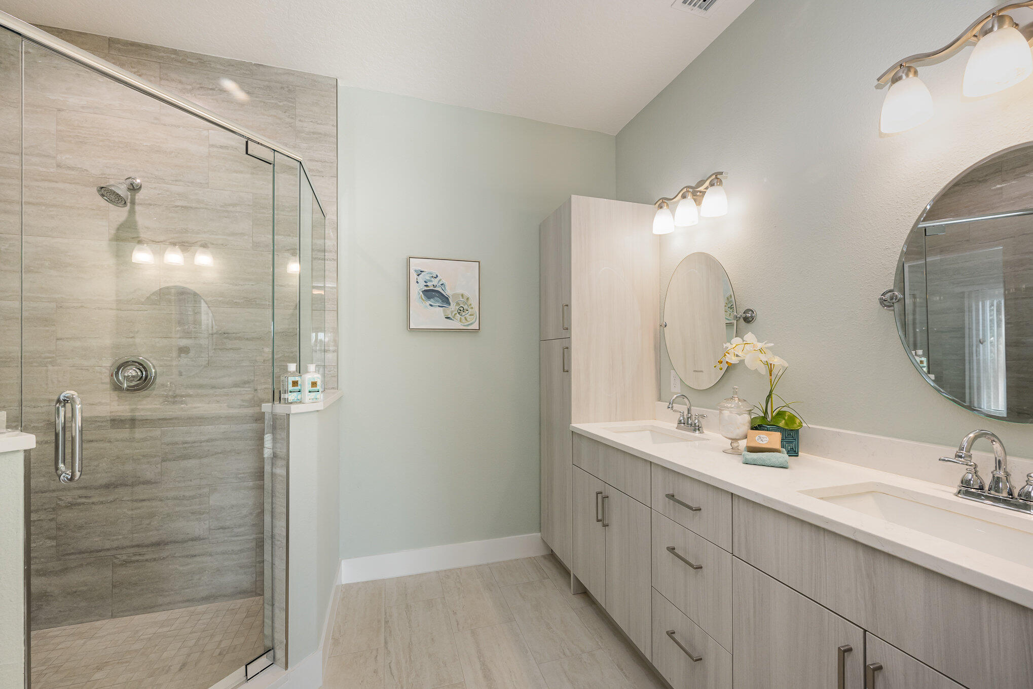 900 Paddleboard Court Melbourne, FL 32935 - Photo 18 of 32 a bathroom with a double vanity sink mirror and shower
