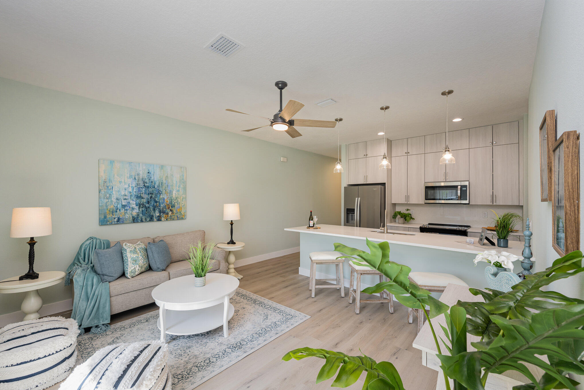 900 Paddleboard Court Melbourne, FL 32935 - Photo 4 of 32 a living room with furniture kitchen view and a potted plant
