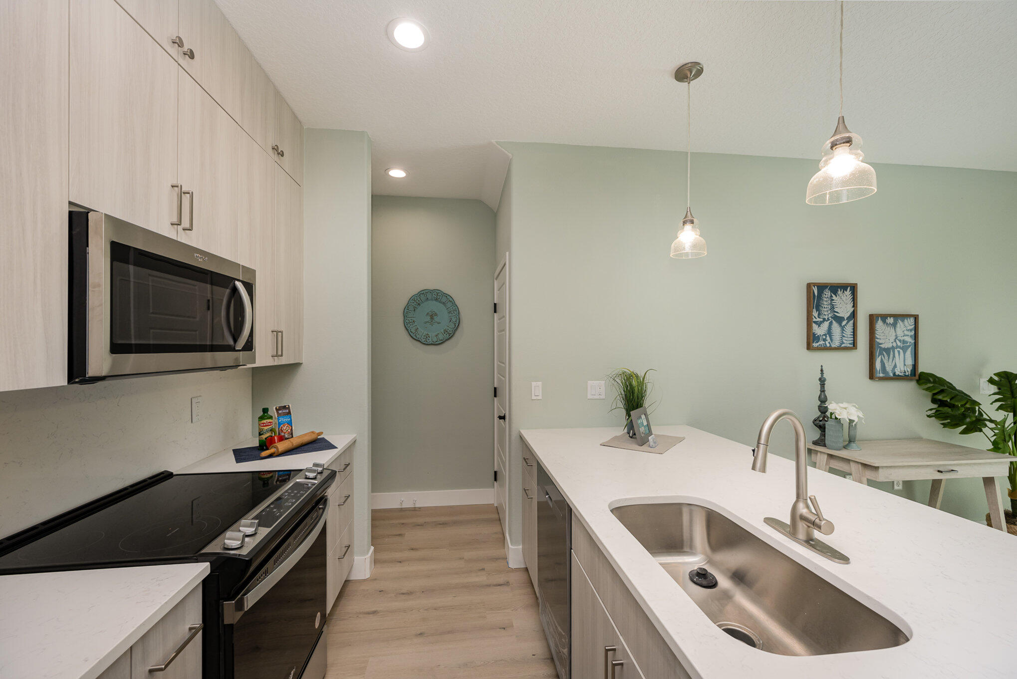 900 Paddleboard Court Melbourne, FL 32935 - Photo 7 of 32 a kitchen with a sink stove and microwave