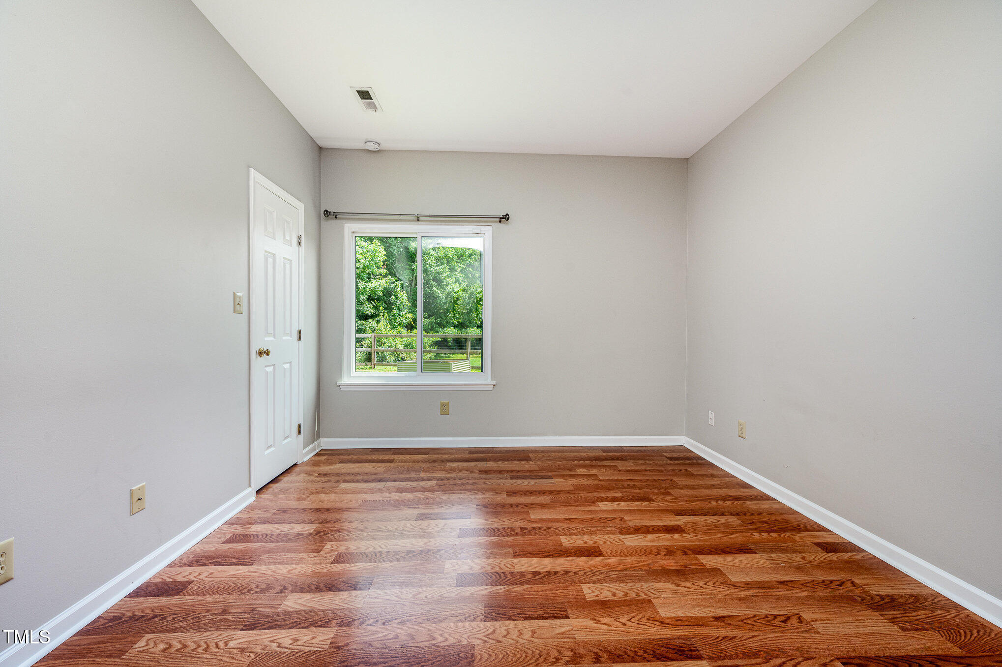6 Blake Court Durham, NC 27712 - Photo 10 of 19 a view of an empty room with wooden floor and a window