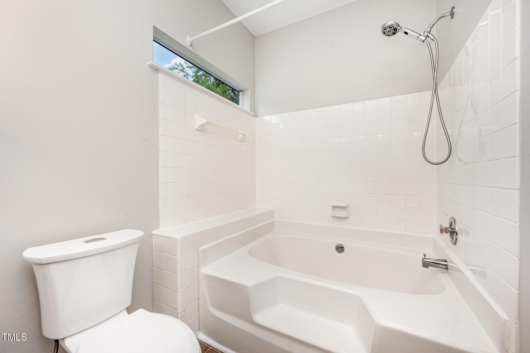 6 Blake Court Durham, NC 27712 - Photo 12 of 19 a white toilet sitting next to a bath tub