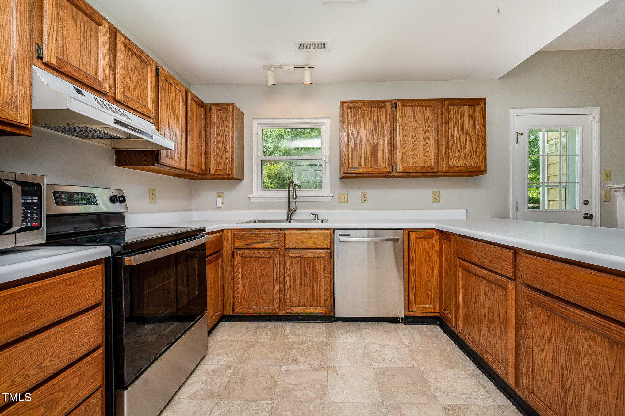 6 Blake Court Durham, NC 27712 - Photo 6 of 19 a kitchen with stainless steel appliances granite countertop wooden cabinets a sink and a stove