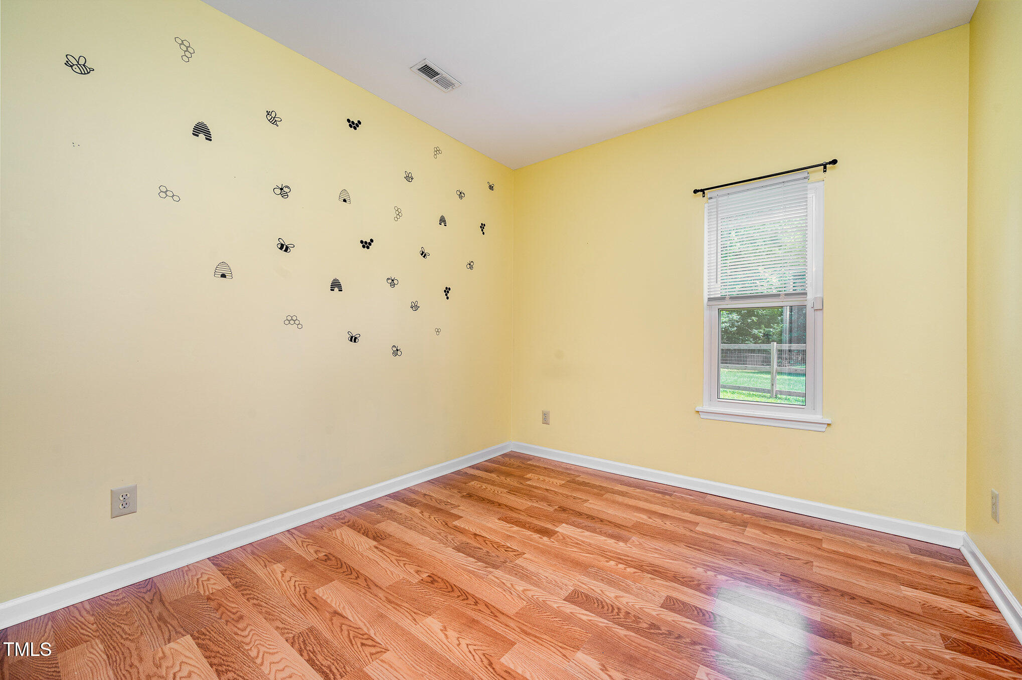 6 Blake Court Durham, NC 27712 - Photo 8 of 19 a view of an empty room with wooden floor and a window