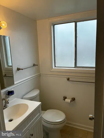 a bathroom with a sink toilet and a mirror