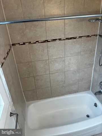 a bathroom with a bathtub and shower
