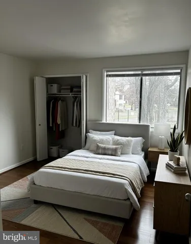a bedroom with a bed and a potted plant