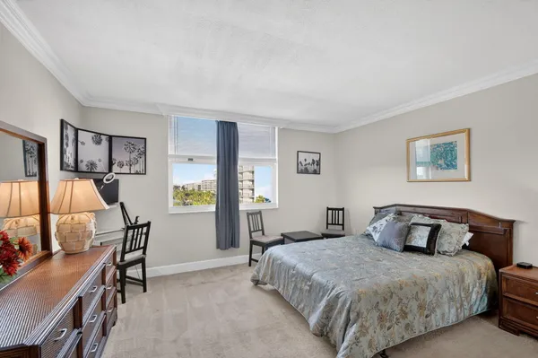 a bedroom with a bed a desk and chair
