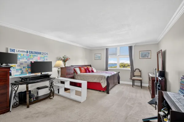 a room with furniture a air conditioner vent and a window