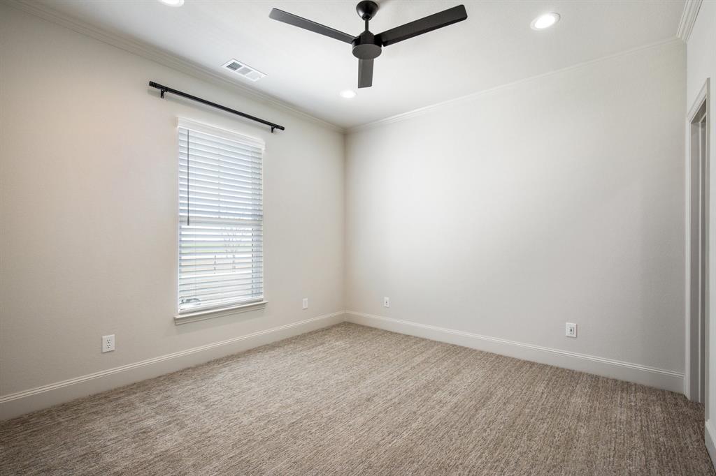 470 Forreston Road Waxahachie, TX 75165 - Photo 33 of 38 Carpeted empty room with visible vents, baseboards, ornamental molding, and a ceiling fan