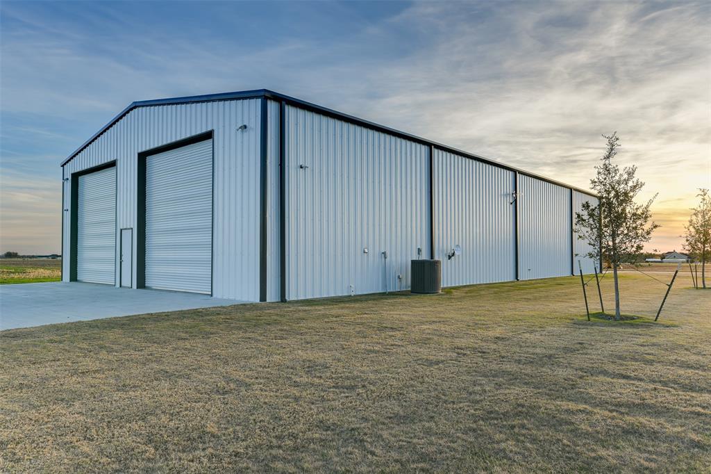 470 Forreston Road Waxahachie, TX 75165 - Photo 5 of 38 Outdoor structure at dusk featuring an outdoor structure, a lawn, and a pole building