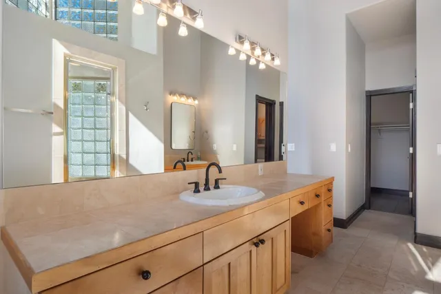 a view of an empty room with wooden floor and a fireplace