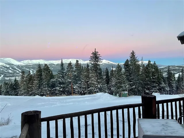 a balcony with wooden floor and city view