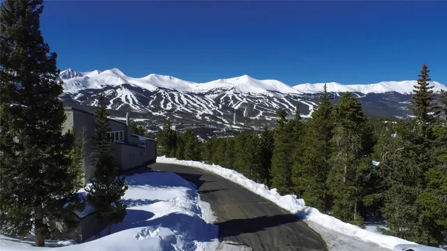 a view of a patio with lawn chairs under an umbrella