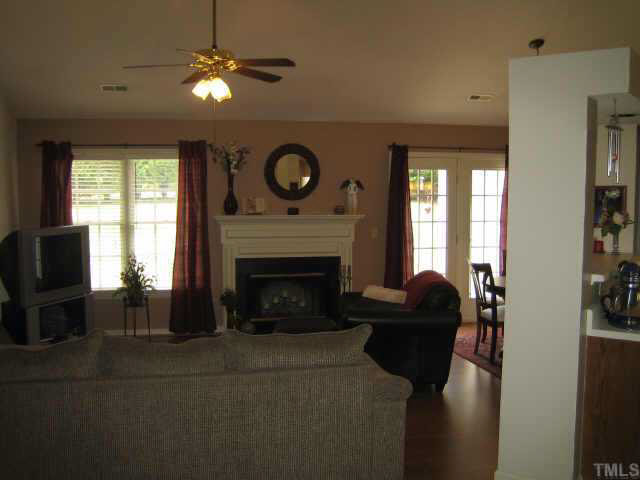 3609 Hopper Street Raleigh, NC 27616 - Photo 2 of 10 Family room with fireplace, ceiling fan and vaulted ceiling is the perfect place to relax or entertain!