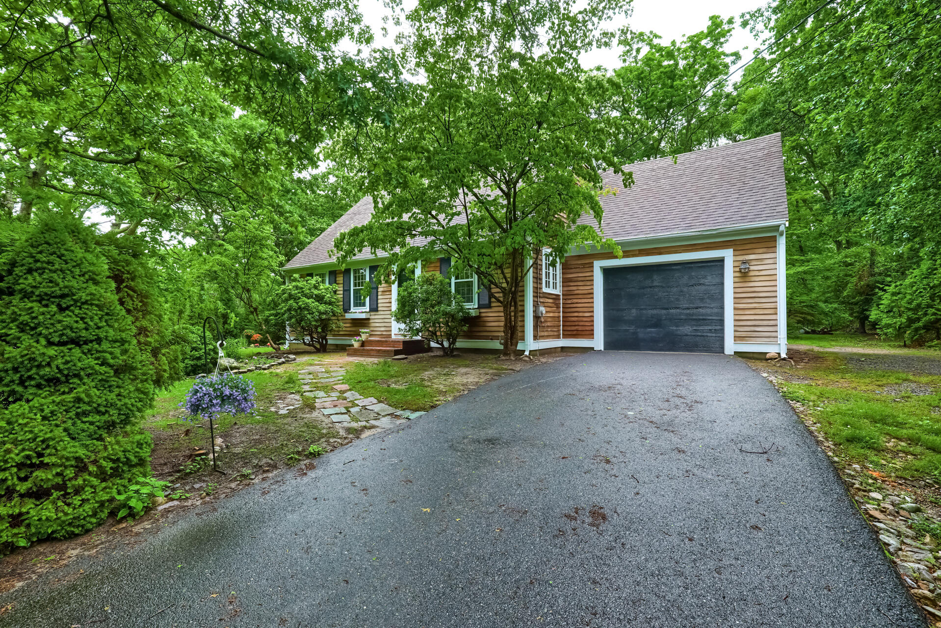 a view of a house with a yard and tree s