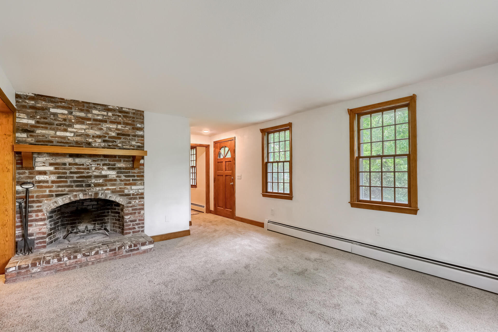 18 Crowell Road Sandwich, MA 02563 - Photo 4 of 31 a view of an empty room with a fireplace and a window
