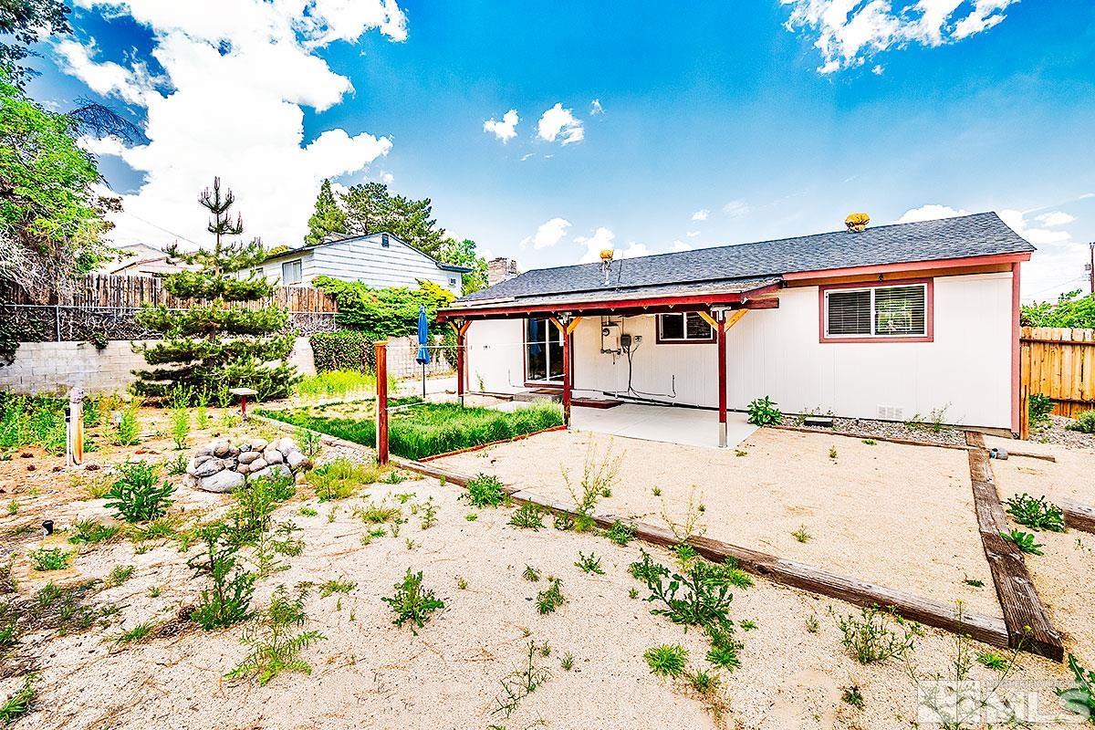 7501 Essex Way Reno, NV 89506 - Photo 13 of 15 a front view of a house with a yard and garage