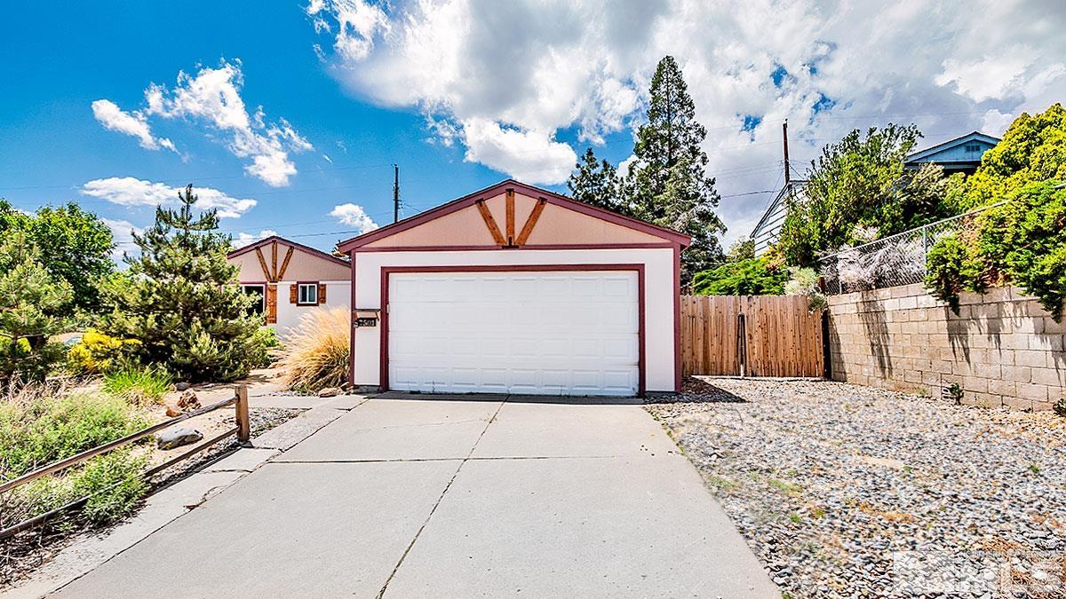 7501 Essex Way Reno, NV 89506 - Photo 2 of 15 a front view of a house with a yard and garage