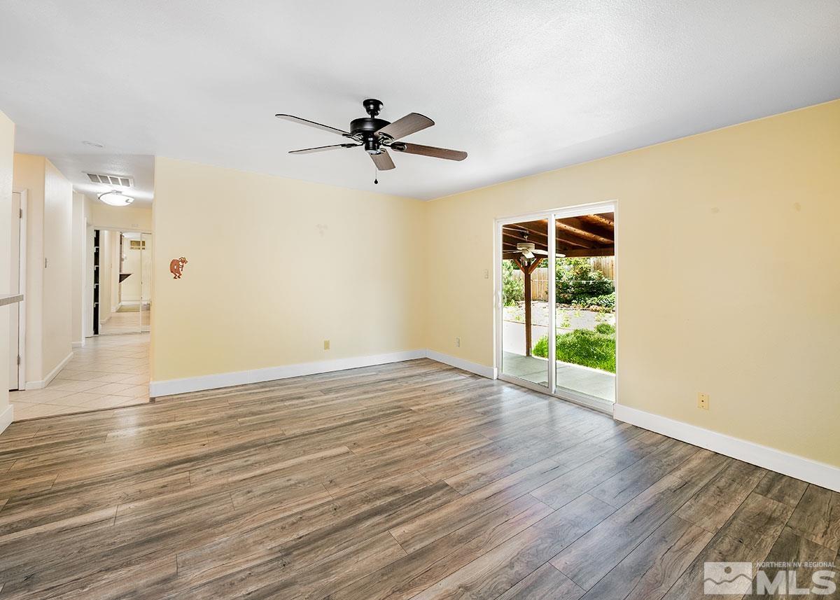 7501 Essex Way Reno, NV 89506 - Photo 4 of 15 a view of empty room with wooden floor and fan