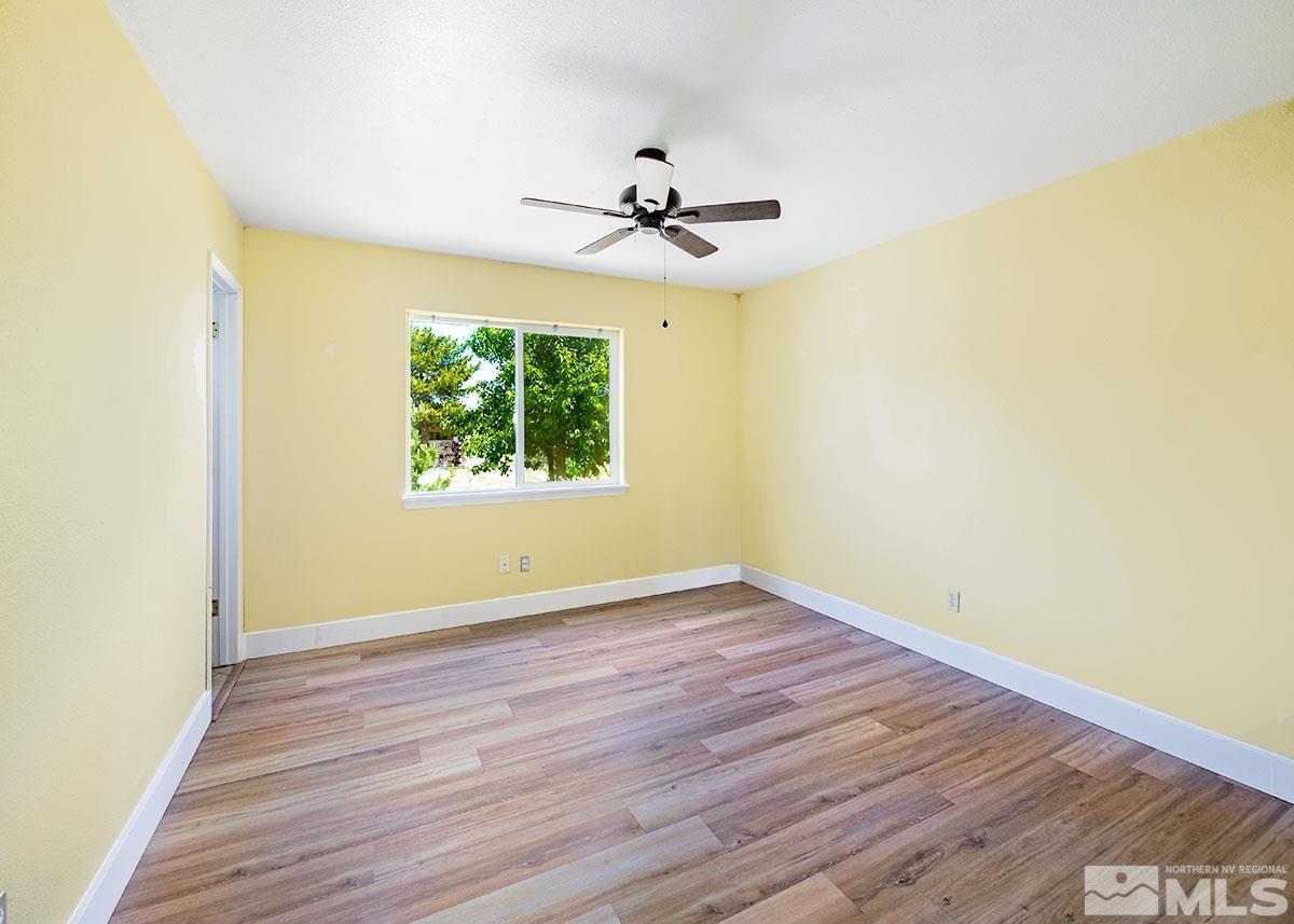 7501 Essex Way Reno, NV 89506 - Photo 8 of 15 an empty room with windows and fan