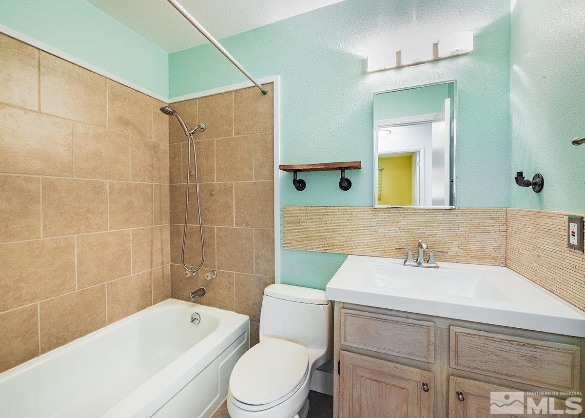 7501 Essex Way Reno, NV 89506 - Photo 10 of 15 a bathroom with a sink a toilet and shower