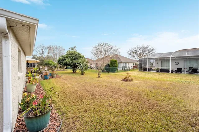 a living room with furniture a chandelier and a large window