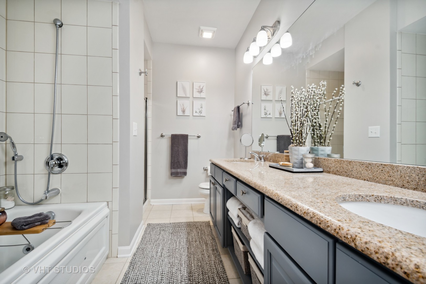 3124 North Seminary Avenue, Unit 1 Chicago, IL 60657 - Photo 14 of 25 a bathroom with a granite countertop sink a toilet a mirror and shower