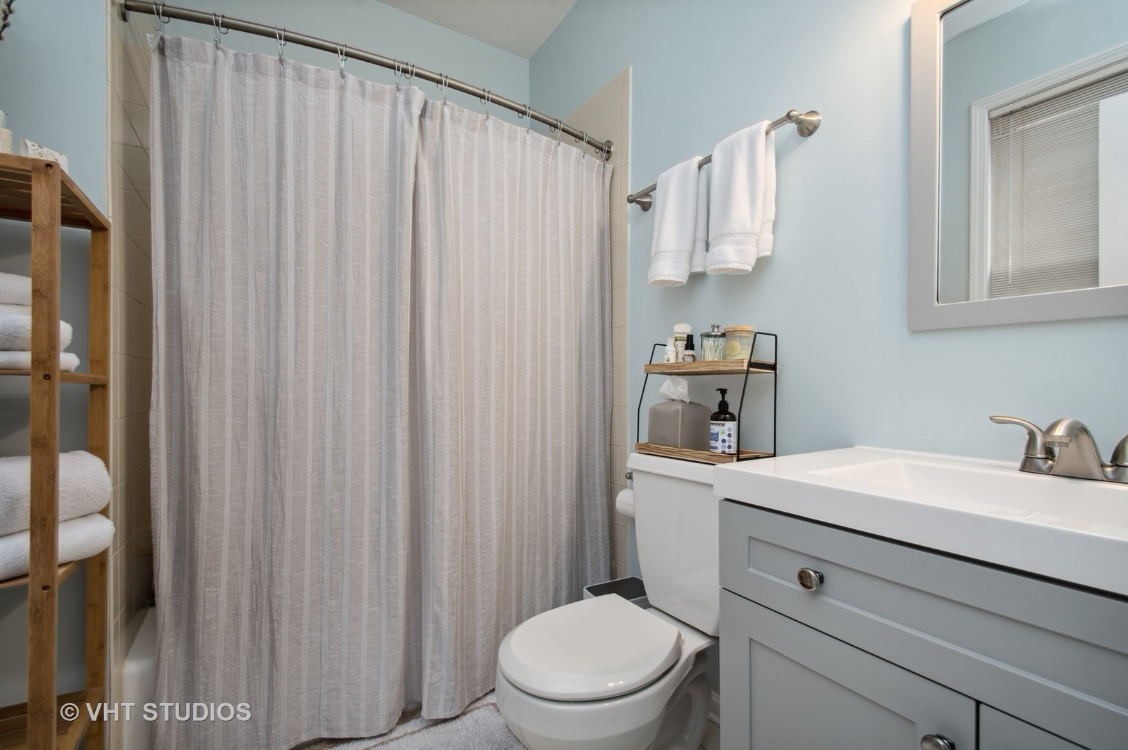 3124 North Seminary Avenue, Unit 1 Chicago, IL 60657 - Photo 18 of 25 a bathroom with a sink a toilet and shower curtain