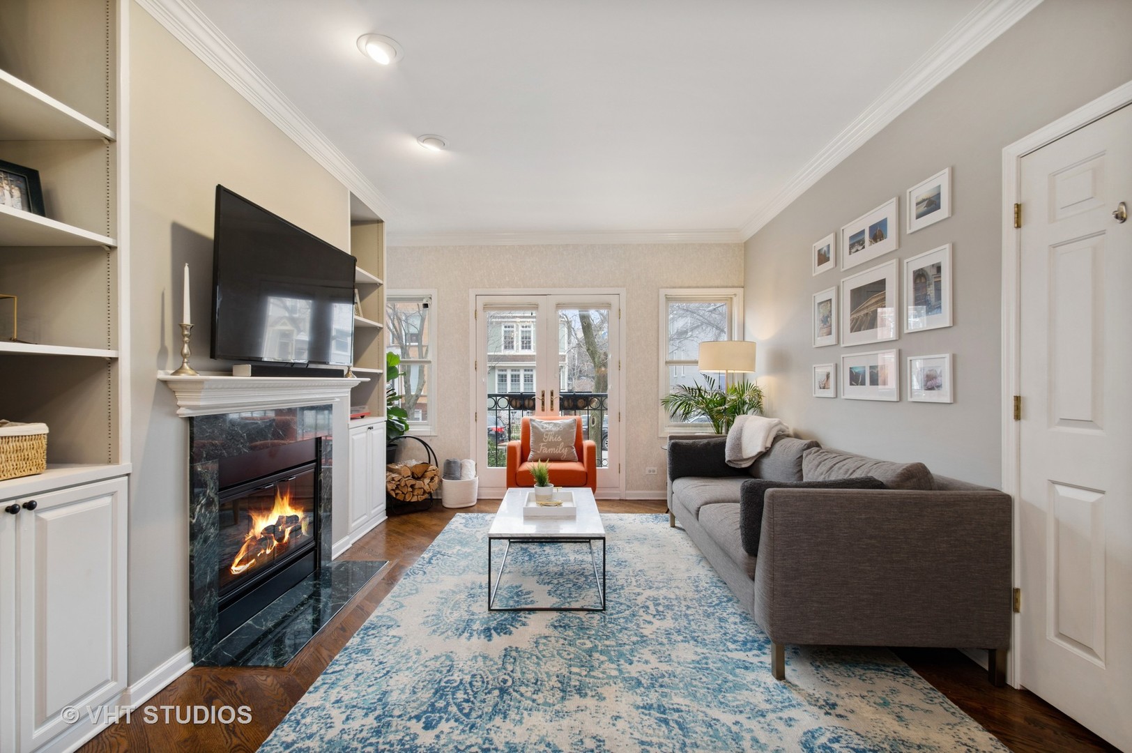 3124 North Seminary Avenue, Unit 1 Chicago, IL 60657 - Photo 2 of 25 a living room with furniture a flat screen tv and a fireplace
