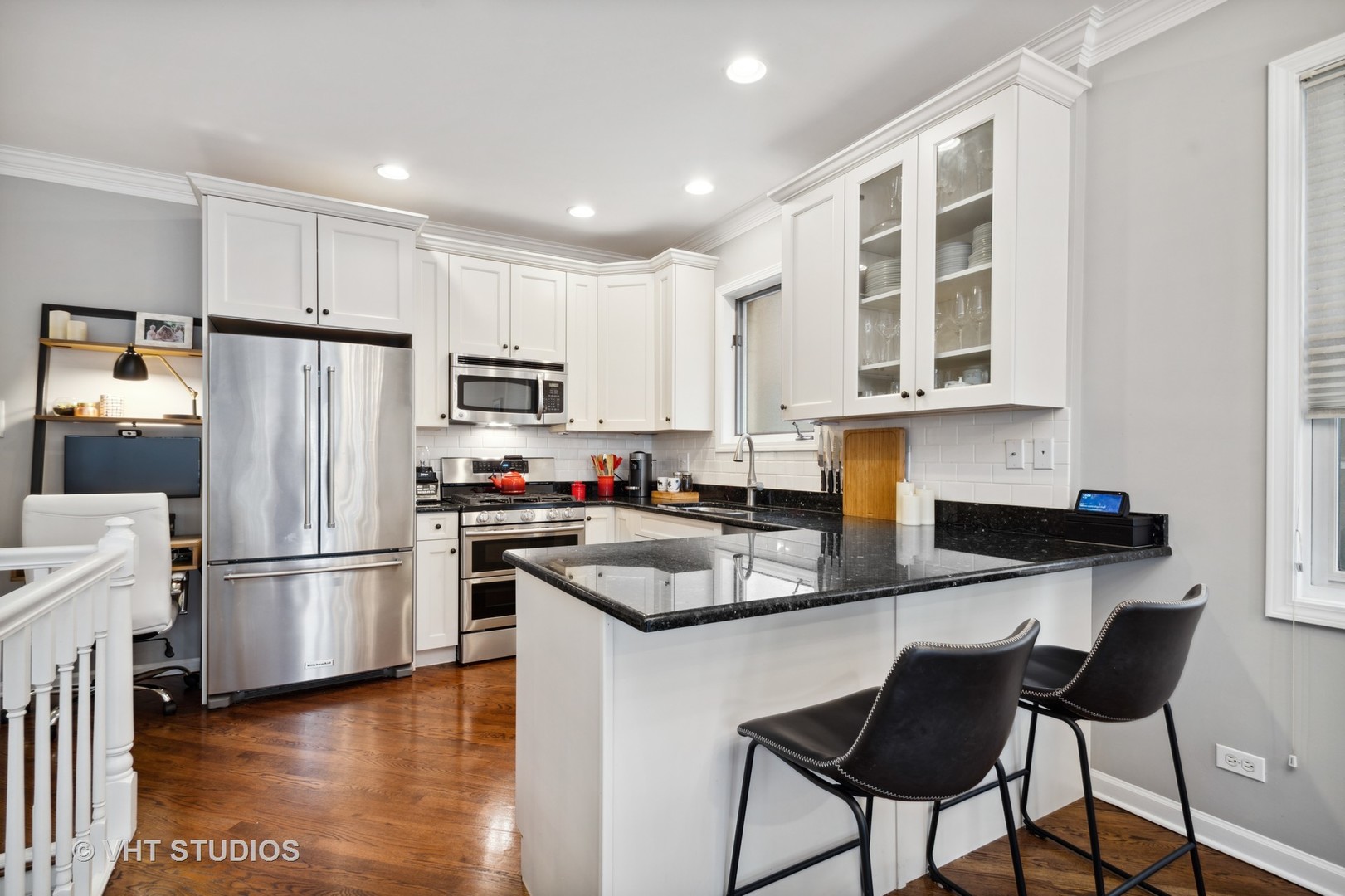 3124 North Seminary Avenue, Unit 1 Chicago, IL 60657 - Photo 5 of 25 a kitchen with stainless steel appliances granite countertop a refrigerator a stove a sink a dining table and chairs