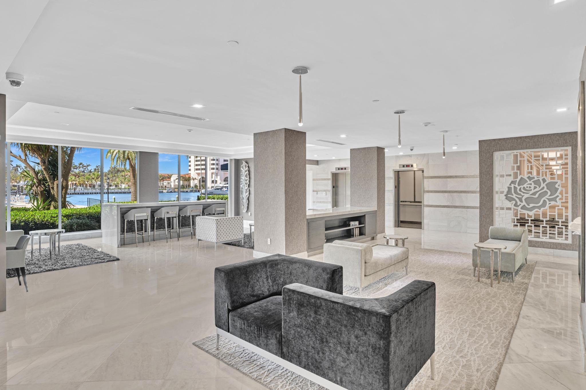 701 East Camino Real, Unit 12G Boca Raton, FL 33432 - Photo 36 of 82 a living room with furniture and large windows