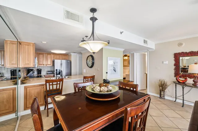 a view of a dining room with furniture and a chandelier