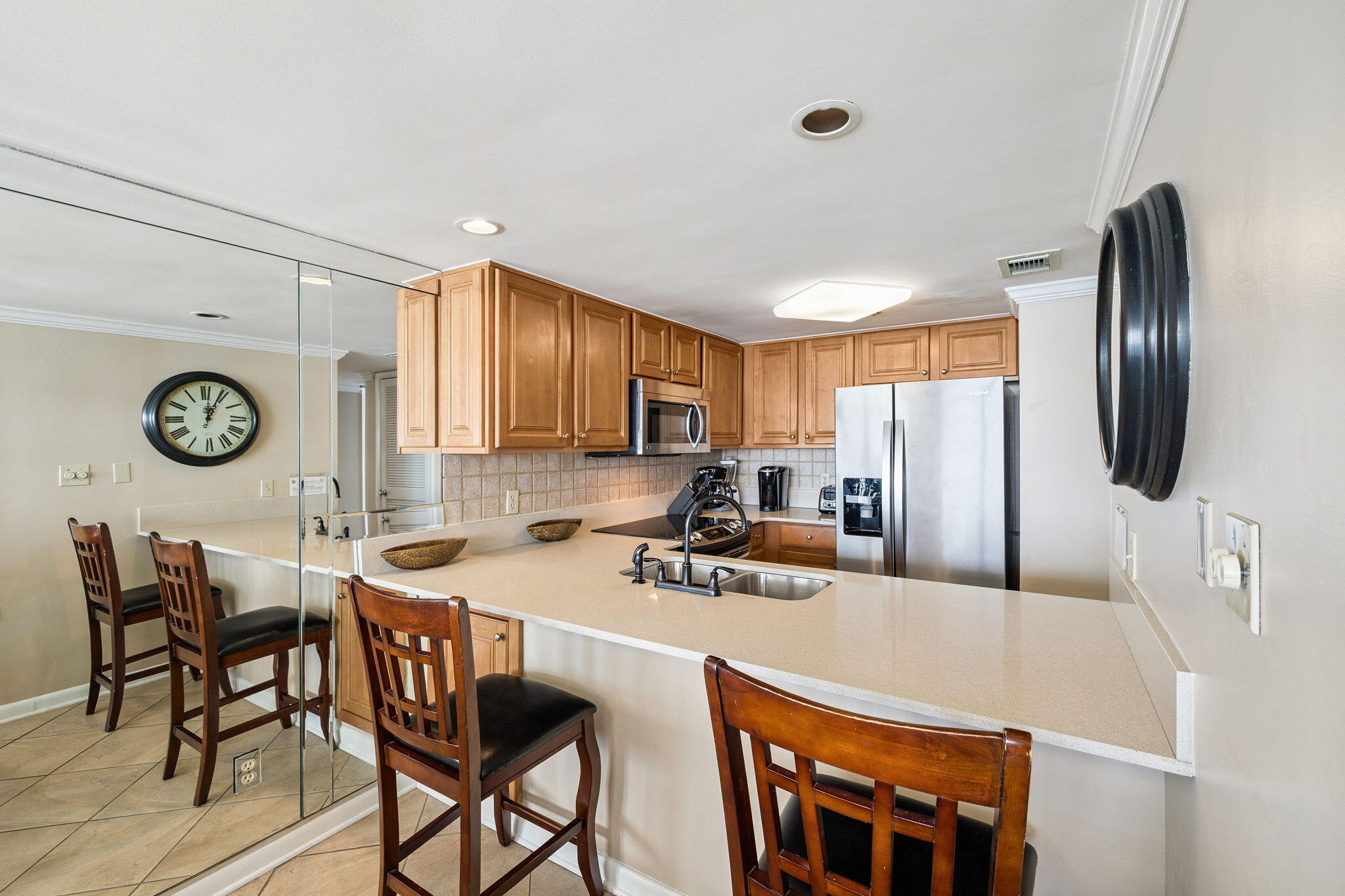 4100 East County Highway 30A, Unit 1606 Santa Rosa Beach, FL 32459 - Photo 13 of 34 a kitchen with stainless steel appliances a table chairs and a refrigerator