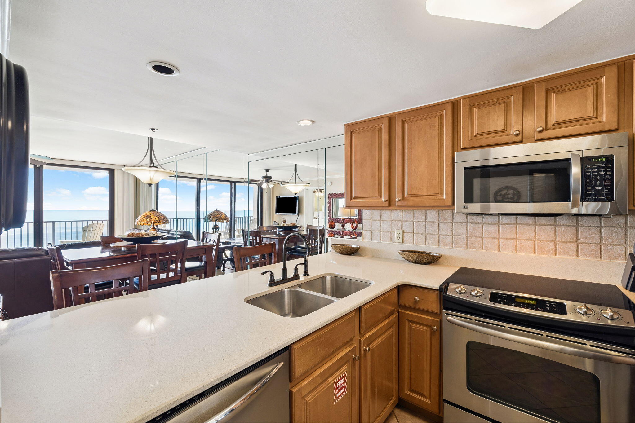 4100 East County Highway 30A, Unit 1606 Santa Rosa Beach, FL 32459 - Photo 15 of 34 a kitchen with stainless steel appliances a stove sink microwave and cabinets