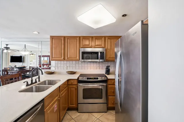 a kitchen with sink a microwave and cabinets