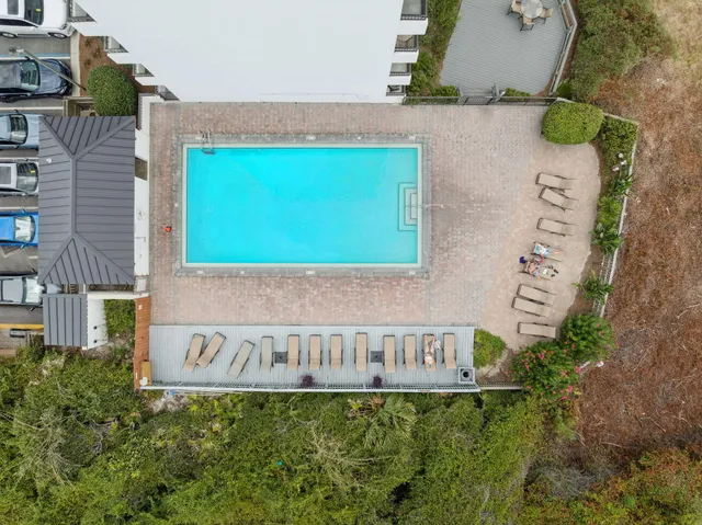 a view of a house with a yard and wooden fence