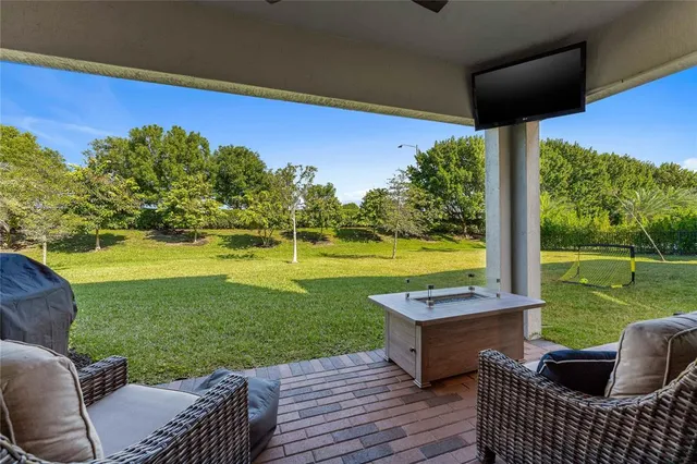 a room with furniture pool table flat screen tv and windows