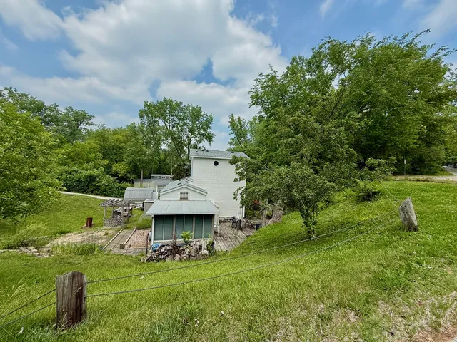 a backyard of a house with table and chairs