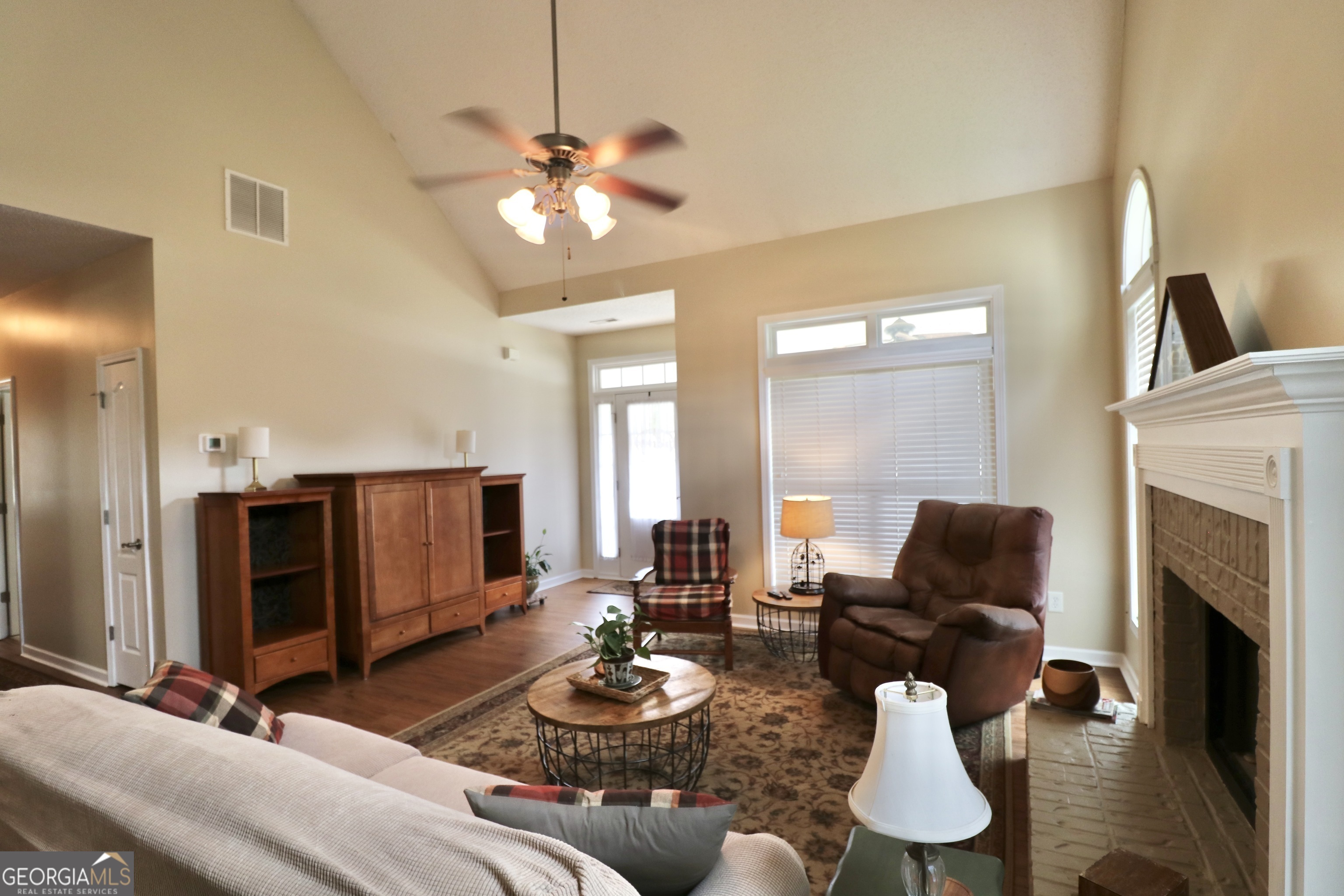 190 Roundtree Way Williamson, GA 30292 - Photo 16 of 73 a living room with furniture kitchen view and a fireplace
