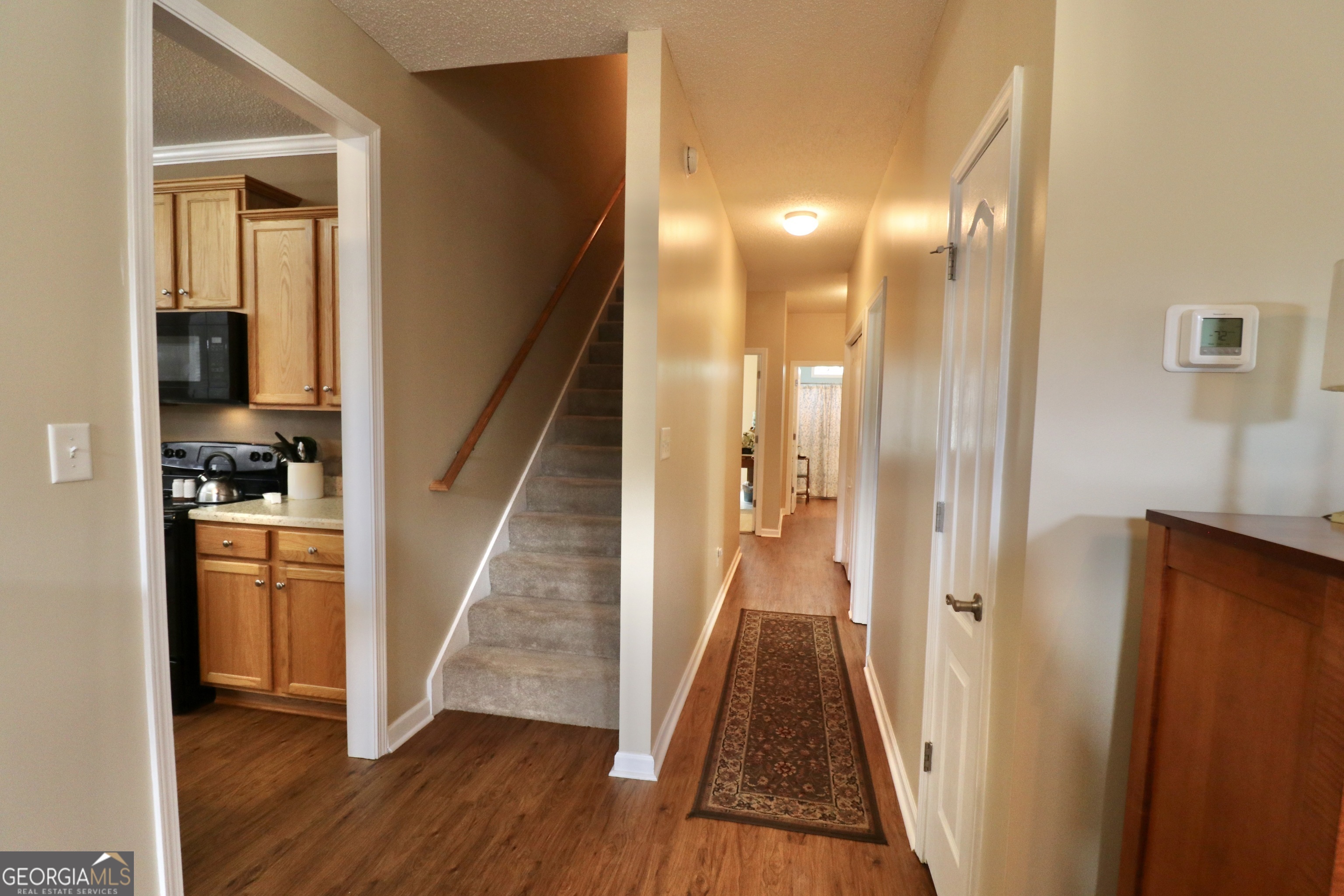 190 Roundtree Way Williamson, GA 30292 - Photo 31 of 73 a view of a hallway with wooden floor and staircase