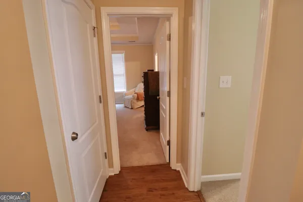 a view of a hallway with a wooden door