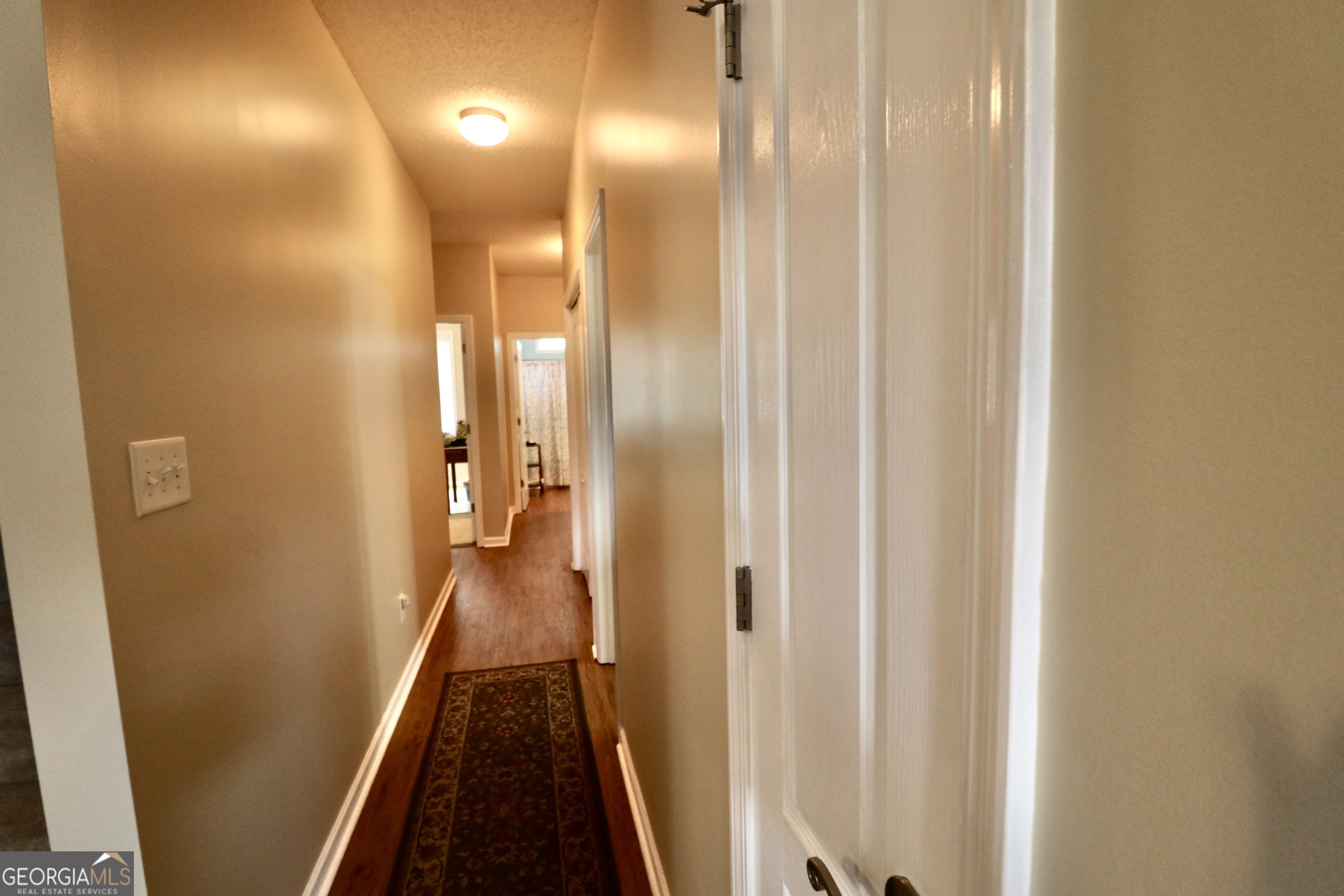 190 Roundtree Way Williamson, GA 30292 - Photo 40 of 73 a view of a hallway with a wooden door